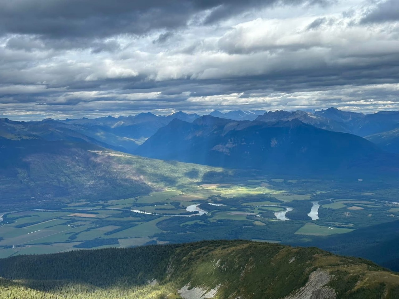 River bends, fields and mountain ridges below Lucille Mountain