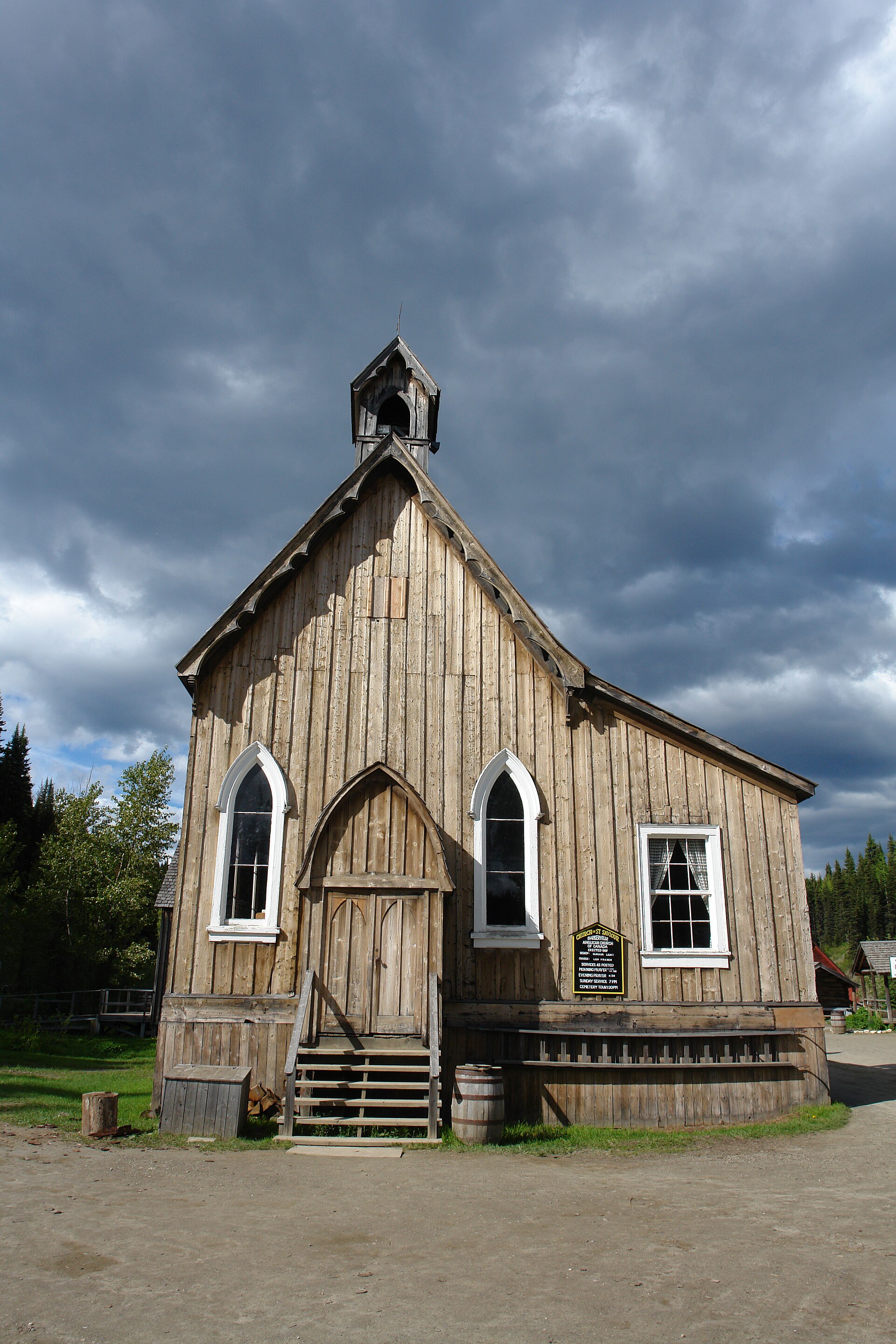 Wooden church beneath clouds in Barkerville