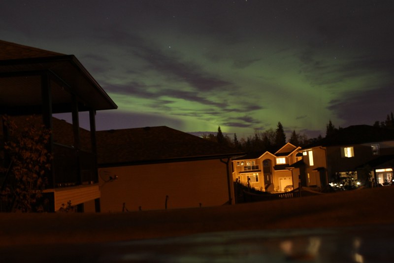 Green aurora above residential rooftops in Prince George