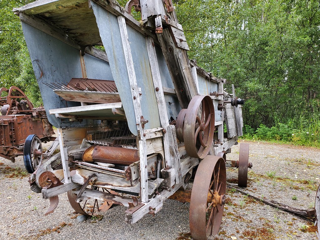 Historic farm machinery beside a gravel path at Cottonwood House
