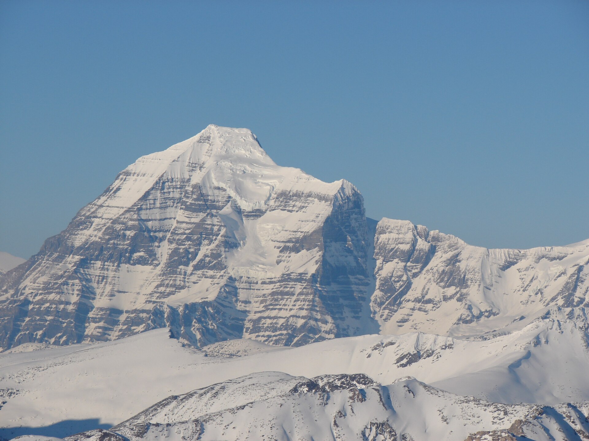 Snow-covered southeast face of Mount Robson seen from Mount McKirdy summit